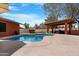 Inviting swimming pool and a covered patio providing shade and seating for outdoor enjoyment at 654 W Plata Ave, Mesa, AZ 85210
