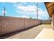 View of the backyard, showing a block wall and gravel landscaping at 7045 S 42Nd St, Phoenix, AZ 85042