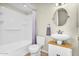 Bathroom featuring single sink vanity, oval mirror and shower over tub with tiled flooring at 7045 S 42Nd St, Phoenix, AZ 85042