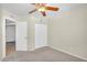 Bright bedroom offers neutral paint, soft carpet, ceiling fan and closet space at 7045 S 42Nd St, Phoenix, AZ 85042