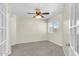 Comfortable bedroom with neutral walls, carpet, ceiling fan, and window letting in natural light at 7045 S 42Nd St, Phoenix, AZ 85042