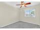 Cozy bedroom features neutral walls, carpet, a ceiling fan and a window with natural light at 7045 S 42Nd St, Phoenix, AZ 85042