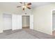 Spacious bedroom features neutral walls, plush carpet, ceiling fan, and large closet for ample storage at 7045 S 42Nd St, Phoenix, AZ 85042