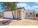 Inviting home exterior featuring a well-kept yard, attached garage, and neutral color palette at 7045 S 42Nd St, Phoenix, AZ 85042
