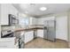 Kitchen showcasing stainless steel appliances, tiled floors, and white cabinets, blending functionality and style at 7045 S 42Nd St, Phoenix, AZ 85042