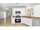 Kitchen view highlighting stainless steel appliances, tiled floors, and white cabinets at 7045 S 42Nd St, Phoenix, AZ 85042