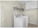 Well-equipped laundry room includes a modern washer and dryer set with overhead storage space at 7045 S 42Nd St, Phoenix, AZ 85042