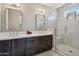 Bright bathroom featuring double vanity sinks and a spacious glass-enclosed shower at 7464 E Paraiso Dr, Scottsdale, AZ 85255