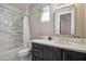 Bright bathroom features a shower-over-tub with marble wall surround, a sleek mirror, and a modern vanity at 7464 E Paraiso Dr, Scottsdale, AZ 85255