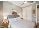 Cozy bedroom with a comfortable bed, side tables, closet, and soft lighting at 7464 E Paraiso Dr, Scottsdale, AZ 85255