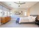 Bright bedroom with large windows, neutral tones, ceiling fan, and stylish furnishings at 7464 E Paraiso Dr, Scottsdale, AZ 85255