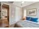 Cozy bedroom features neutral walls, modern ceiling fan, and a picture window that provides ample light at 7464 E Paraiso Dr, Scottsdale, AZ 85255