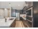 Modern kitchen with stainless appliances, gas cooktop and large island with bar seating at 7464 E Paraiso Dr, Scottsdale, AZ 85255