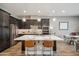 Modern kitchen with large island, stainless steel appliances, and dark wood cabinets at 7464 E Paraiso Dr, Scottsdale, AZ 85255