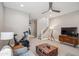 Open living room with a ceiling fan, Peloton bike, modern decor, and lots of light at 7464 E Paraiso Dr, Scottsdale, AZ 85255