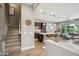 Open-concept living space featuring a modern kitchen and a comfortable living area with staircase at 7464 E Paraiso Dr, Scottsdale, AZ 85255