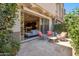 Cozy outdoor patio with comfortable seating area and a view into the home's living space at 7464 E Paraiso Dr, Scottsdale, AZ 85255