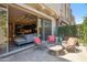 Inviting outdoor patio with stylish seating and views through sliding glass doors to the interior living space at 7464 E Paraiso Dr, Scottsdale, AZ 85255