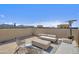 Roof deck features comfortable couches with concrete coffee table, modern chairs, and overhead heating at 7464 E Paraiso Dr, Scottsdale, AZ 85255