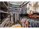Large walk-in closet with ample storage, organized shelving, and hanging racks at 7464 E Paraiso Dr, Scottsdale, AZ 85255