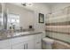 Bathroom featuring a single sink, granite countertops, and a shower/tub combo with curtain at 7531 E Billings St # 116, Mesa, AZ 85207
