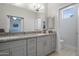 Bathroom featuring double sinks, granite countertops, and a view to the bedroom via a sliding door at 7531 E Billings St # 116, Mesa, AZ 85207
