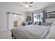 Bedroom featuring queen-sized bed and a set of sliding barn doors to the ensuite bathroom at 7531 E Billings St # 116, Mesa, AZ 85207