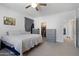 Bedroom features a queen-sized bed, gray dresser, and an entrance to the walk-in closet at 7531 E Billings St # 116, Mesa, AZ 85207