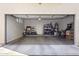 Garage with overhead storage and concrete floor with personal items like Costco boxes and bicycles at 7531 E Billings St # 116, Mesa, AZ 85207