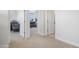 Hallway leading into a carpeted room with white walls, natural light, and connecting rooms at 7531 E Billings St # 116, Mesa, AZ 85207