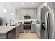 Modern kitchen featuring gray cabinets, stainless steel appliances, a white countertop, and tile flooring at 7531 E Billings St # 116, Mesa, AZ 85207
