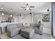 Bright living room featuring a comfortable gray sectional sofa and an open floor plan at 7531 E Billings St # 116, Mesa, AZ 85207