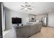Inviting living room showcases a large TV and view of the stylish, open kitchen at 7531 E Billings St # 116, Mesa, AZ 85207