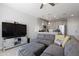 Open-concept living room with modern kitchen, a large TV, and comfortable seating area at 7531 E Billings St # 116, Mesa, AZ 85207