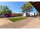 Spacious backyard featuring artificial turf, desert landscaping, covered patio, and detached structure at 8111 E Jerome Ave, Mesa, AZ 85209