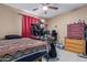 Bedroom featuring a ceiling fan, work desk, and neutral-colored walls at 8111 E Jerome Ave, Mesa, AZ 85209