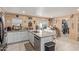 Modern kitchen featuring granite countertops, white cabinets, and an island with bar seating at 8111 E Jerome Ave, Mesa, AZ 85209