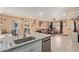 Living room and kitchen area with neutral walls, tile flooring, and great lighting at 8111 E Jerome Ave, Mesa, AZ 85209