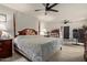 Spacious main bedroom with a four-poster bed, ceiling fan, and access to the backyard at 8111 E Jerome Ave, Mesa, AZ 85209
