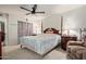 Bright main bedroom featuring wood-look tile flooring, a ceiling fan, and ample natural light at 8111 E Jerome Ave, Mesa, AZ 85209