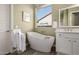 Chic bathroom with a freestanding tub, designer fixtures, and ample natural light for a spa-like experience at 9059 E Leonora St. St, Mesa, AZ 85207
