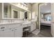 Elegant bathroom with dual sinks, white cabinetry, and a separate vanity area for added convenience at 9059 E Leonora St. St, Mesa, AZ 85207