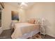 This bedroom features a ceiling fan, decor, and a queen sized bed with decorative pillows at 9059 E Leonora St. St, Mesa, AZ 85207