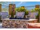 Inviting outdoor seating around a stone fire pit, perfect for relaxing evenings with friends and Gathering at 9059 E Leonora St. St, Mesa, AZ 85207