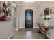 Warm and inviting foyer with decorative iron door, neutral walls, tile floors, and elegant rustic console table at 9059 E Leonora St. St, Mesa, AZ 85207