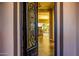 Elegant entryway featuring an ornate iron door, hardwood floors, and a view of the backyard at 9059 E Leonora St. St, Mesa, AZ 85207