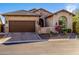 Charming home exterior with a three car garage and beautifully landscaped front yard at 9059 E Leonora St. St, Mesa, AZ 85207