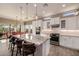 Bright kitchen with large island, granite countertops, stainless appliances, and adjacent dining area at 9059 E Leonora St. St, Mesa, AZ 85207