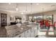 Bright, open kitchen with granite countertops, stainless appliances, and seamless access to an outdoor dining space at 9059 E Leonora St. St, Mesa, AZ 85207