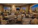Luxurious covered patio space with a stone fireplace and ample seating, perfect for outdoor gatherings at 9059 E Leonora St. St, Mesa, AZ 85207